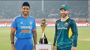 Indian captain Suryakumar Yadav (L) with Australian captain Matthew Wade (R) posing with 5 T20Is match series trophy