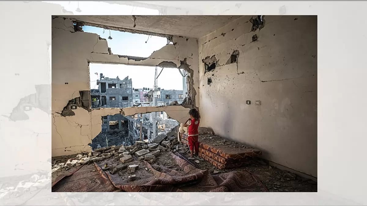 A Palestinian girl stands amid the rubble of her destroyed home in Beit Hanoun, Gaza