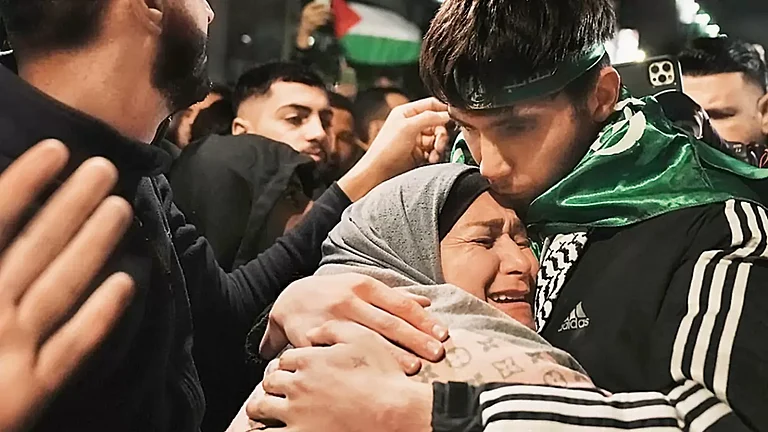 Omar Atshan, a Palestinian prisoner released by Israel in exchange of hostages abducted by Hamas, hugs his mother. - null