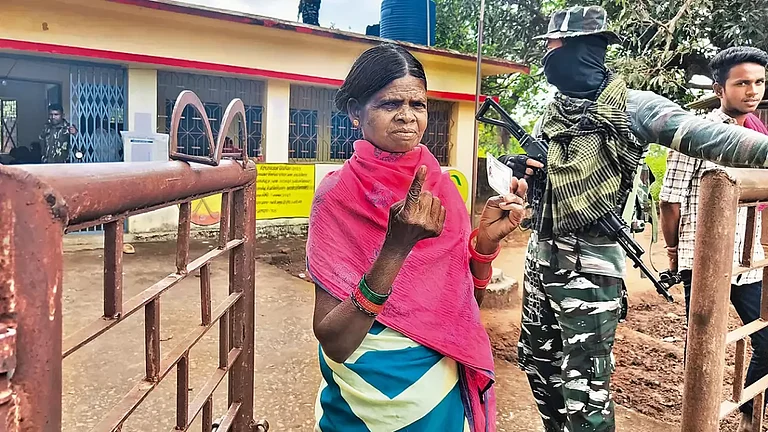 Exercising Their Right: A woman proudly shows she has cast her vote - null