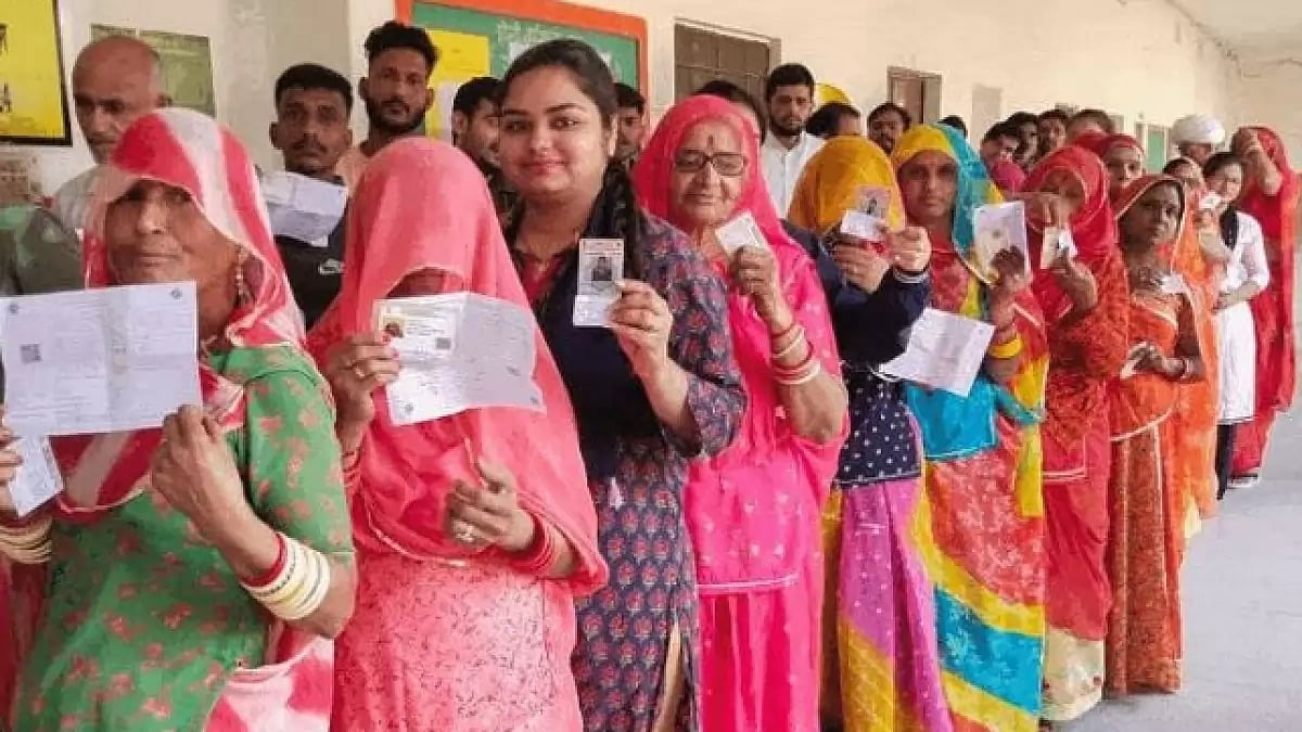 Women voters standing in a queue at a polling booth in Rajasthan