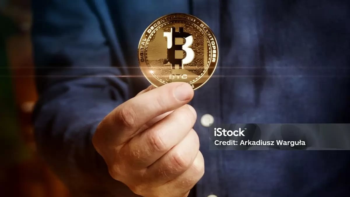 Person holds physical Bitcoin in hand