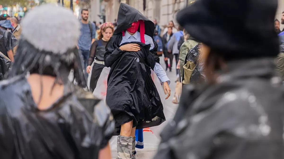 A group of capitalist activists performing and giving away clothes during in Barcelona 