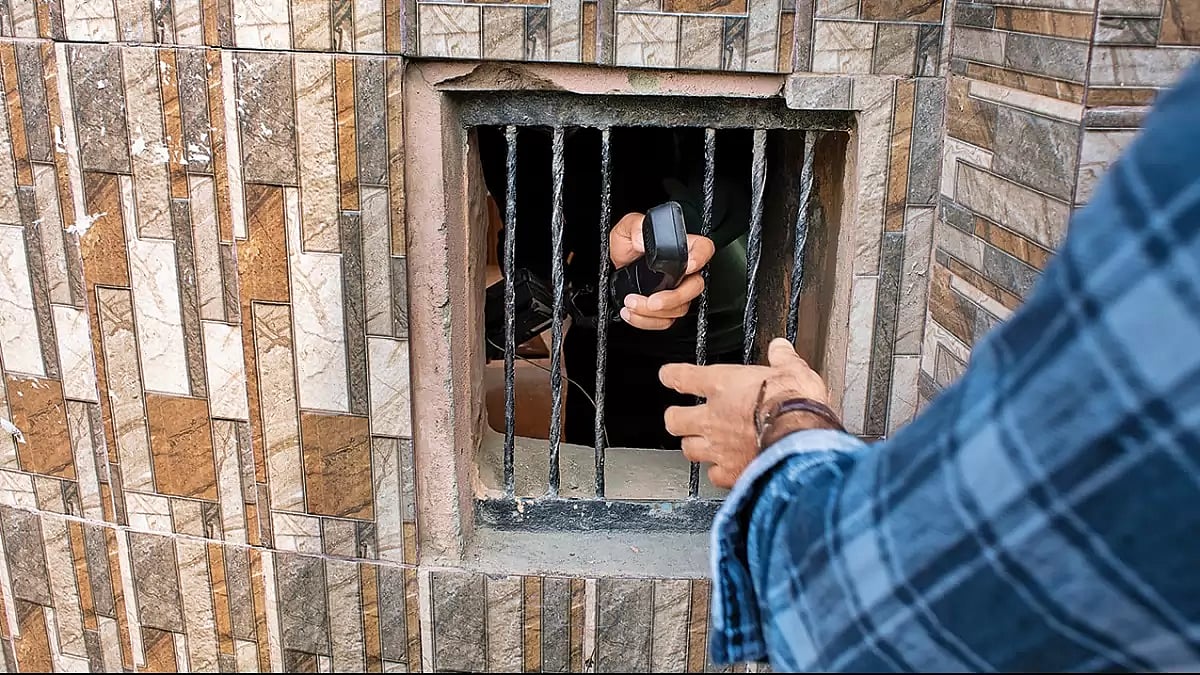 Redacted: A Kashmiri man helps another to speak on a landline phone as cell phones and internet services were suspended