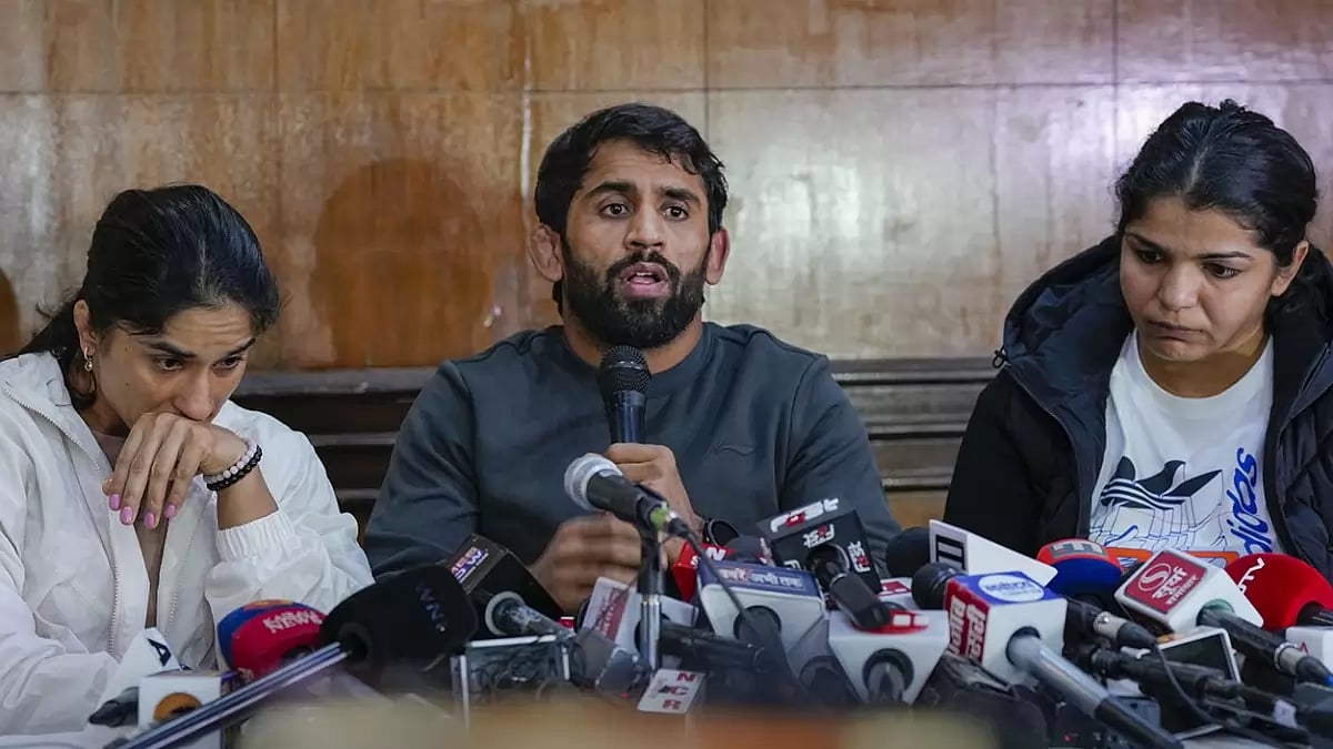 (File Photo)  : Wrestlers Vinesh Phogat, Bajrang Punia and Sakshi Malik address a press conference after Sanjay Singh, an associate of BJP MP and former chief of Wrestling Federation of India (WFI) Brij Bhushan Sharan Singh, became the new President of WFI, in New Delhi.