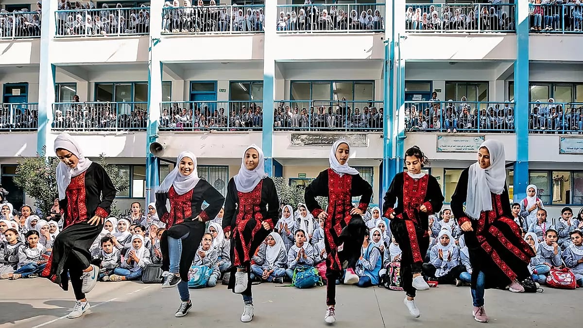 Matching Steps: Palestinian students perform Dabke at the Young Musician Concert organised by the Edward Said National Conservatory of Music at Beit Hanoun Secondary School in Gaza City