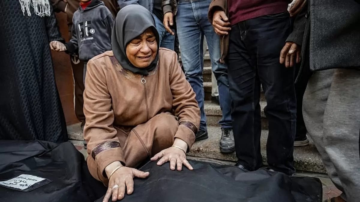  A Palestinian women mourns near the body of her relative in Khan Yunis