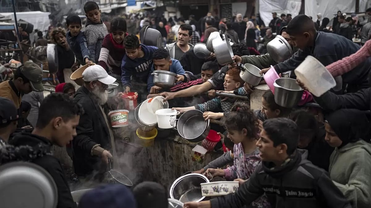 Palestinians converge for a free meal in Rafah, Gaza Strip, Thursday, Dec. 21, 2023