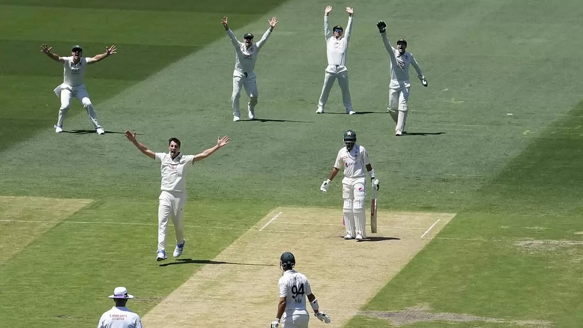 Australias Pat Cummins, third left, appeals for a LBW decision against Pakistans Babar Azam, second right, who is given out on review during the third cricket Test match in Sydney.