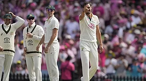 Australia's Mitchell Starc, right, gestures after bowling Pakistan's Abdullah Shafique on the third day of their cricket Test match in Sydney.