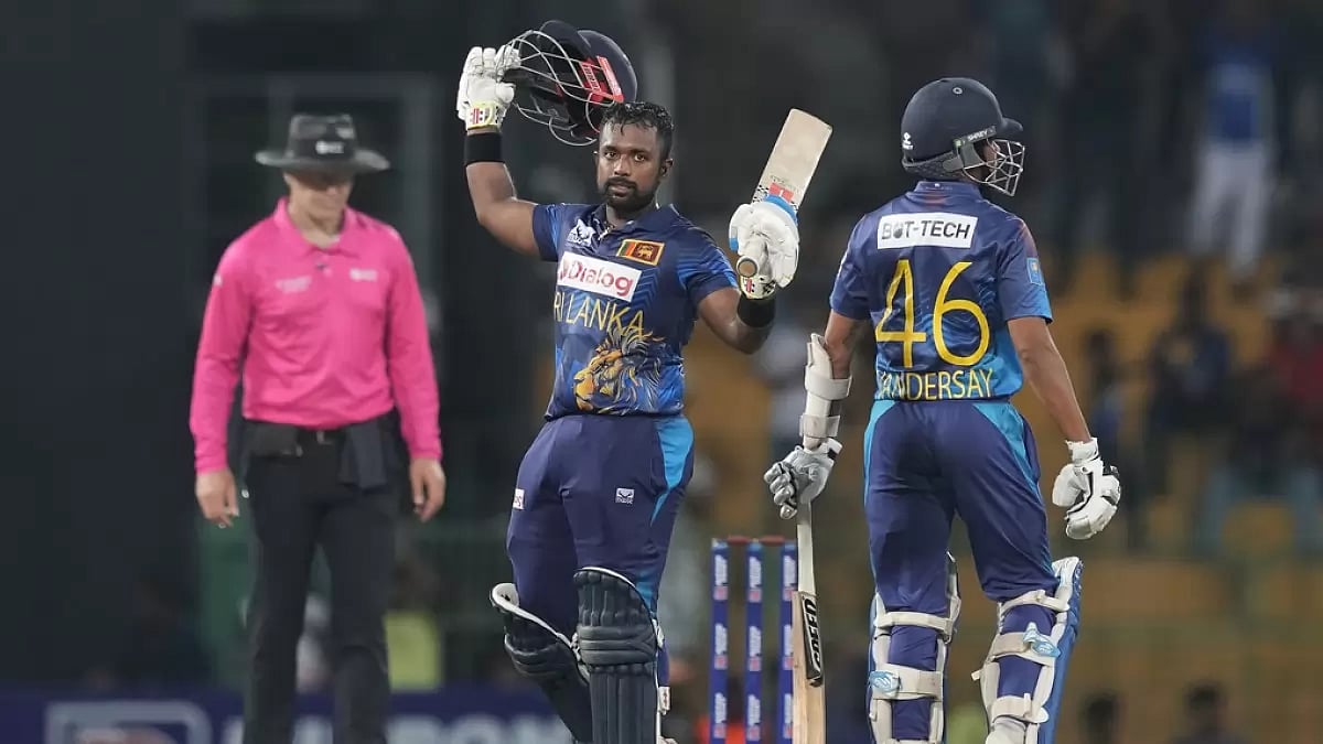 Charith Asalanka (C) celebrates scoring a century during the first ODI cricket match between Sri Lanka and Zimbabwe in Colombo.