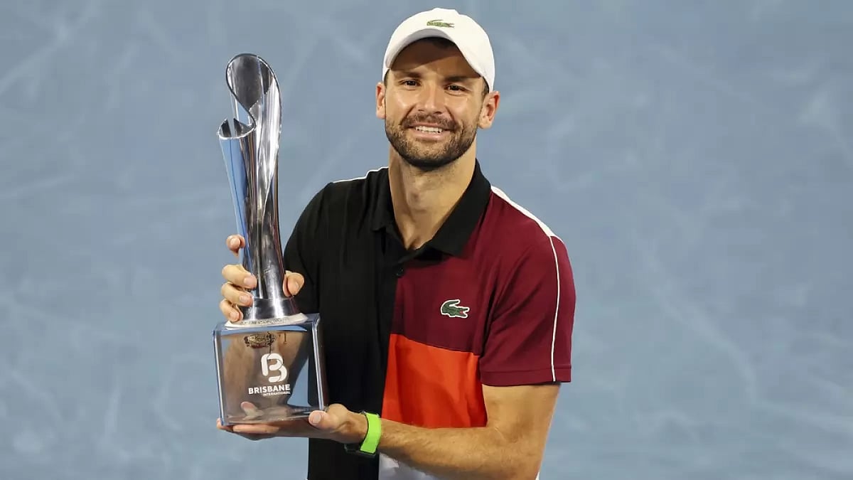 Grigor Dimitrov of Bulgaria poses with the trophy after he won his final match against Holger Rune
