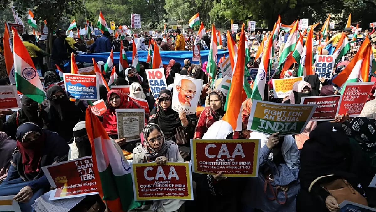Demonstrators hold up flags and placards while gathering to protest against the Citizen (Amendment) Act (CAA) at Jantar Mantar, Delhi.