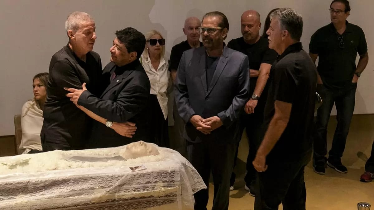 Brazilian football confederation president Ednaldo Rodrigues, centre, embraces Mario Cesar Zagallo, left, son of legendary coach and player Mario Zagallo, during a funeral service in Rio de Janeiro.