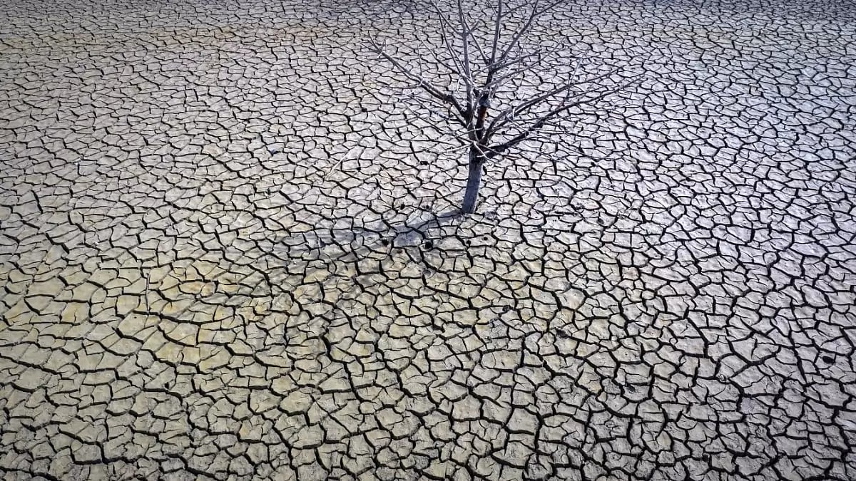 The cracked earth of the Sau reservoir is visible north of Barcelona, Spain.