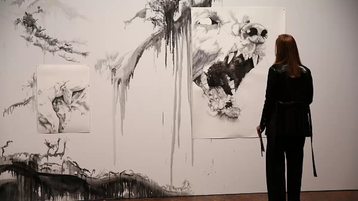 A visitor looks at the work 