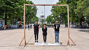 Activists standing on a block of ice with a noose tied around their neck as a sign of protest against global warming in Kolkata in 2022