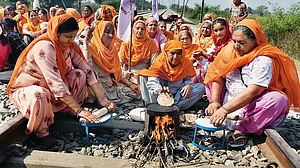 Women farmers in Amritsar making chapatis on a railway track during the ‘rail roko’ agitation in 2020 against the central government’s farm laws