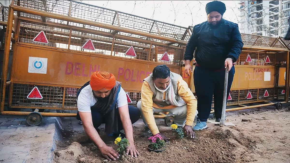 Farmers sow flowers next to the iron rails placed by the Delhi Police in Ghazipur (Delhi-UP border) in 2021 - null