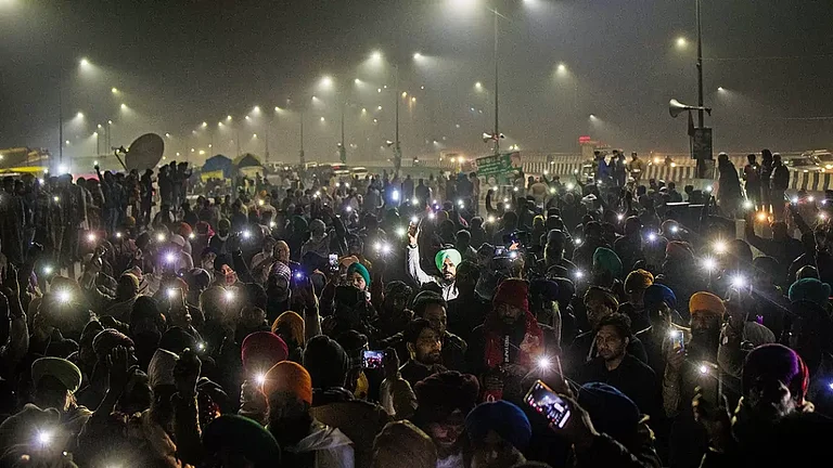 Protestors flash their mobile torches in the memory of 40 farmers who lost their lives during the 2020 protests in Ghaziabad. - null
