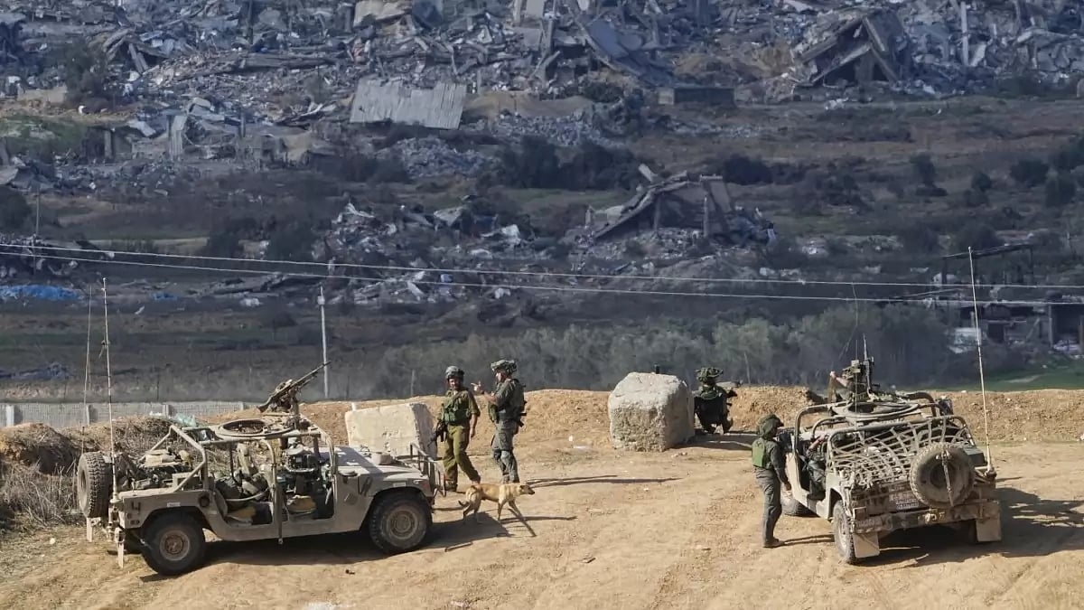 Israeli soldiers take up positions near the Gaza strip.