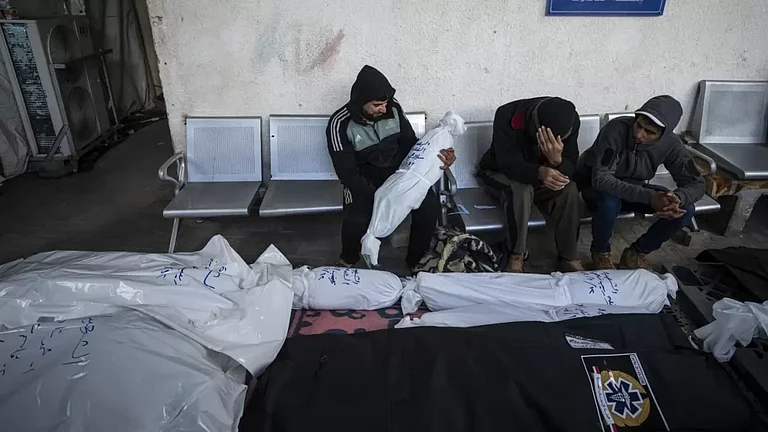 Palestinians mourn deaths of their relatives. - null