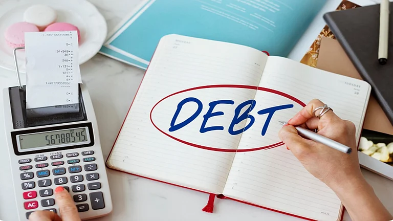 Use debt for value-creating needs like education or homeownership, not for short-term wants like vacations or luxury items. - Freepik