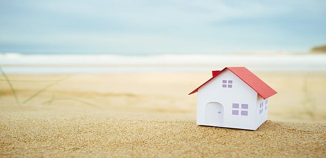 What are the tax implications on a property investment for an NRI?