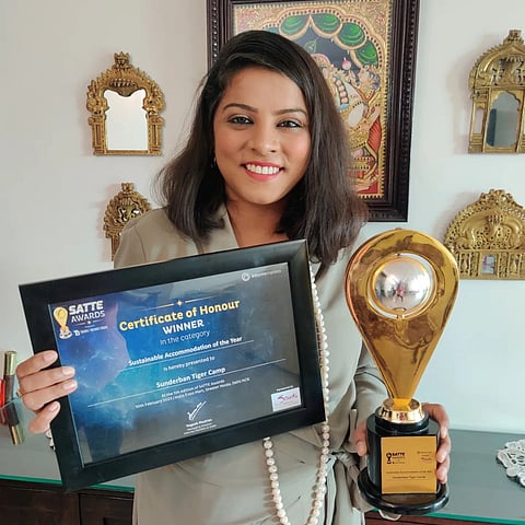Akanksha Garg posing with the sustainable accommodation award given to the Sunderban Tiger Camp by South Asia's Travel and Tourism Exchange (SATTE) 