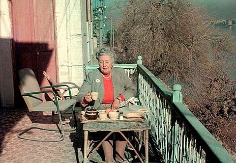 Detective fiction writer Agatha Christie having breakfast on the hotel balcony overlooking the Tigris in Baghdad