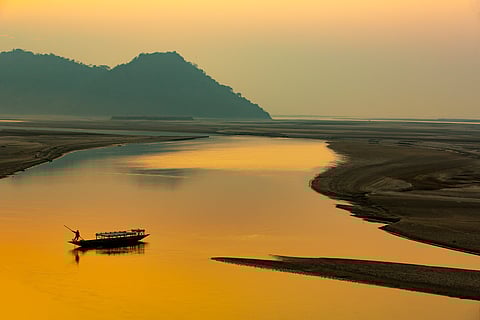 Silhouette of a man rowing a boat, Mayong, Brahmaputra river, Assam