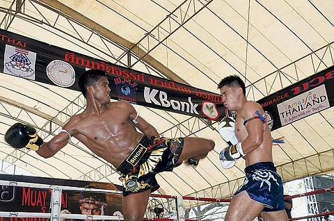 Thailand's  Welterweight champion Sombat 'Buakaw' Banchamek delivers a knockout kick to his Chinese challenger Wei Chao Chen