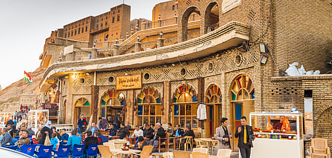 A caf in Erbil, with the Erbil Qalat citadel in the background