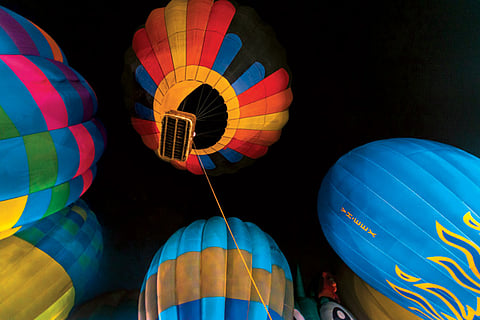 Propane-fuelled flames and bright colours dispel the darkness at Agra's PAC Ground, where the pros performed a tethered flight
