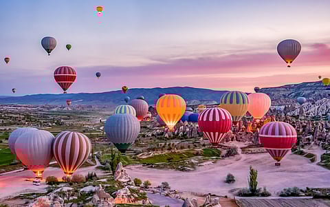 The evening sky dotted with vibrant balloons in Goreme national park