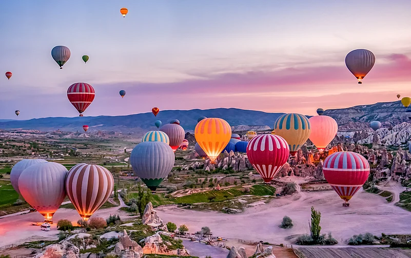 The evening sky dotted with vibrant balloons in Goreme national park