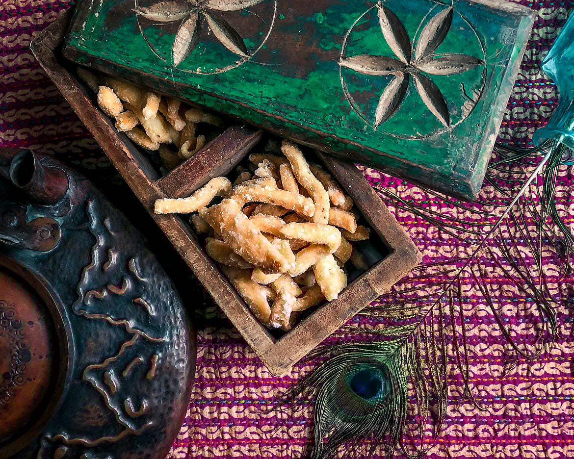 Shakkar paare are fried dough fingerlings dipped in a sugar solution