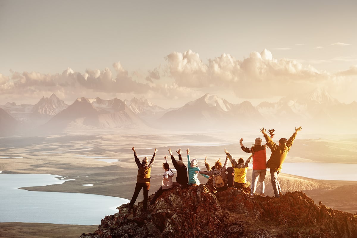 A group of travellers celebrating a summit 