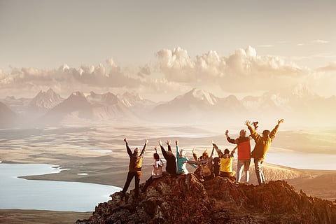 A group of travellers celebrating a summit