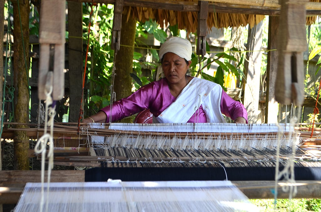 A Khampti woman weaving a pha-noi at her house in Emong village