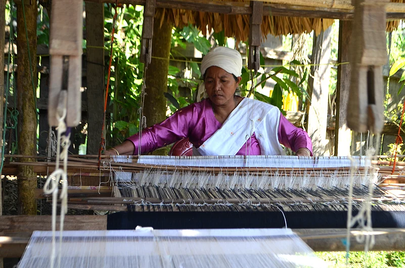 A Khampti woman weaving a pha-noi at her house in Emong village