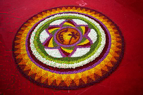 A Pookalam design with a homage to Kerala in the centre