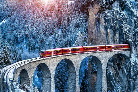 Aerial view of a train passing through a mountain in Filisur, Switzerland