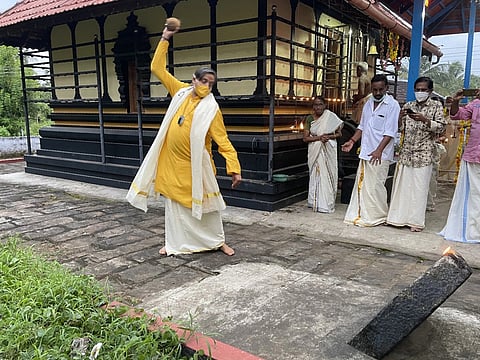 Tharoor smashing the ritual coconut at Elevanchery Bhagavathy Kshetram on Onam day
