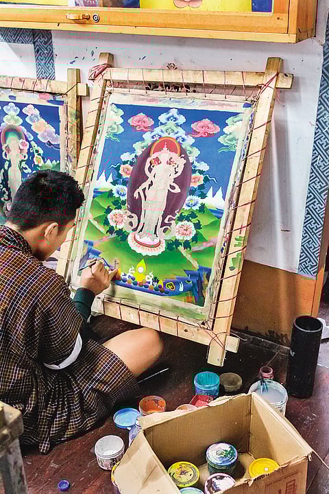 An artist painting Thangka