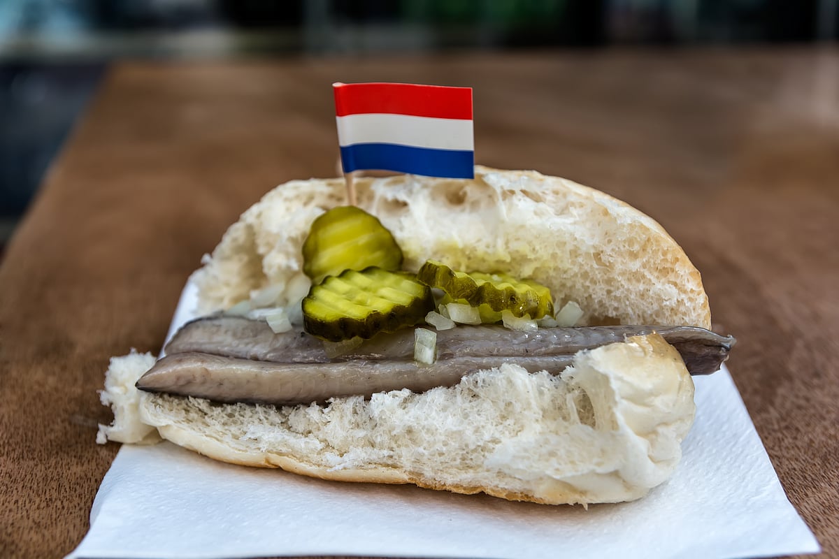 Seafood sandwich with herring, onions and pickled cucumber