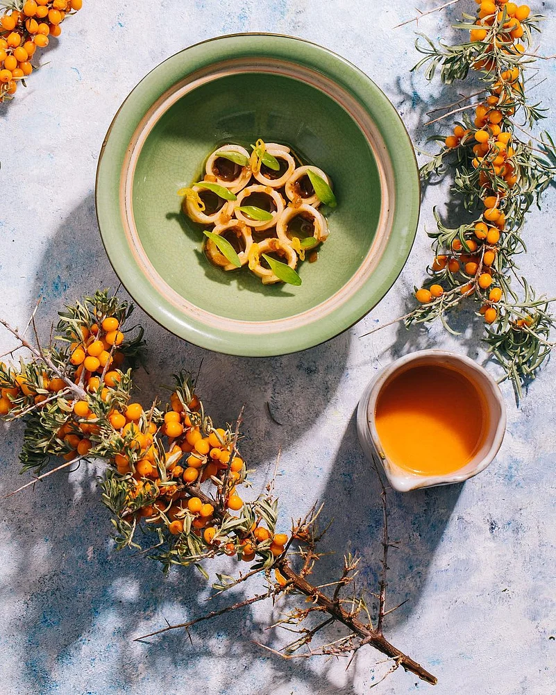 Sea buckthorn juice paired with 3 elements. A house-made veg XO sauce, roasted pineapple and squid, with a drizzle of fresh green pepper oil at Masque, Mumbai