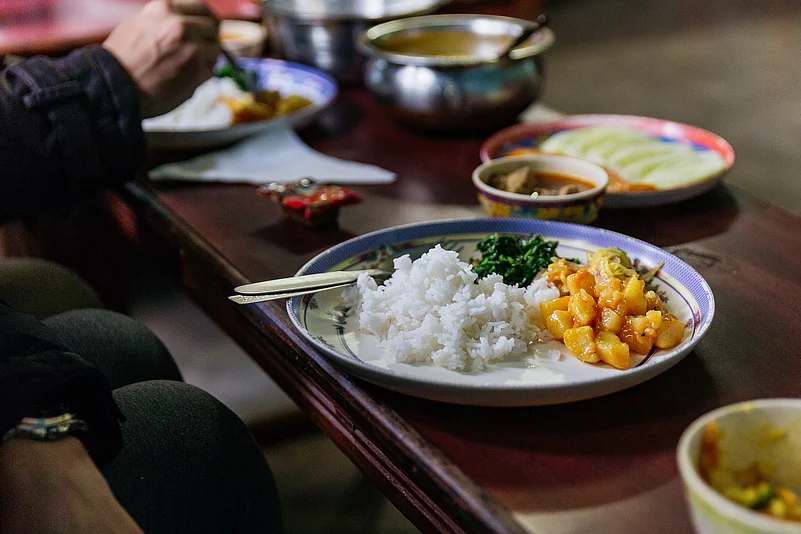 Steamed rice with curry soup and vegetables at a restaurant in North Sikkim