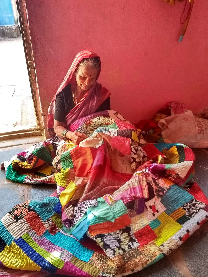 A kowdhi quilt is constructed by repurposing old cloth, often a combination of patterned and plain pieces.