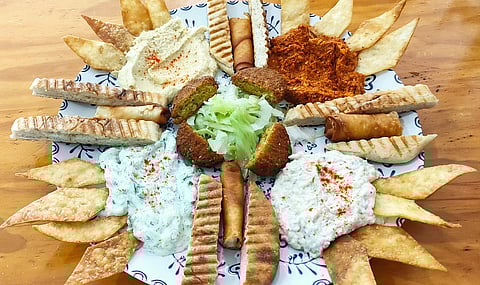 A Turkish platter comprising hummus, haydari, muammara, babaganus, sigara boregi and falafel